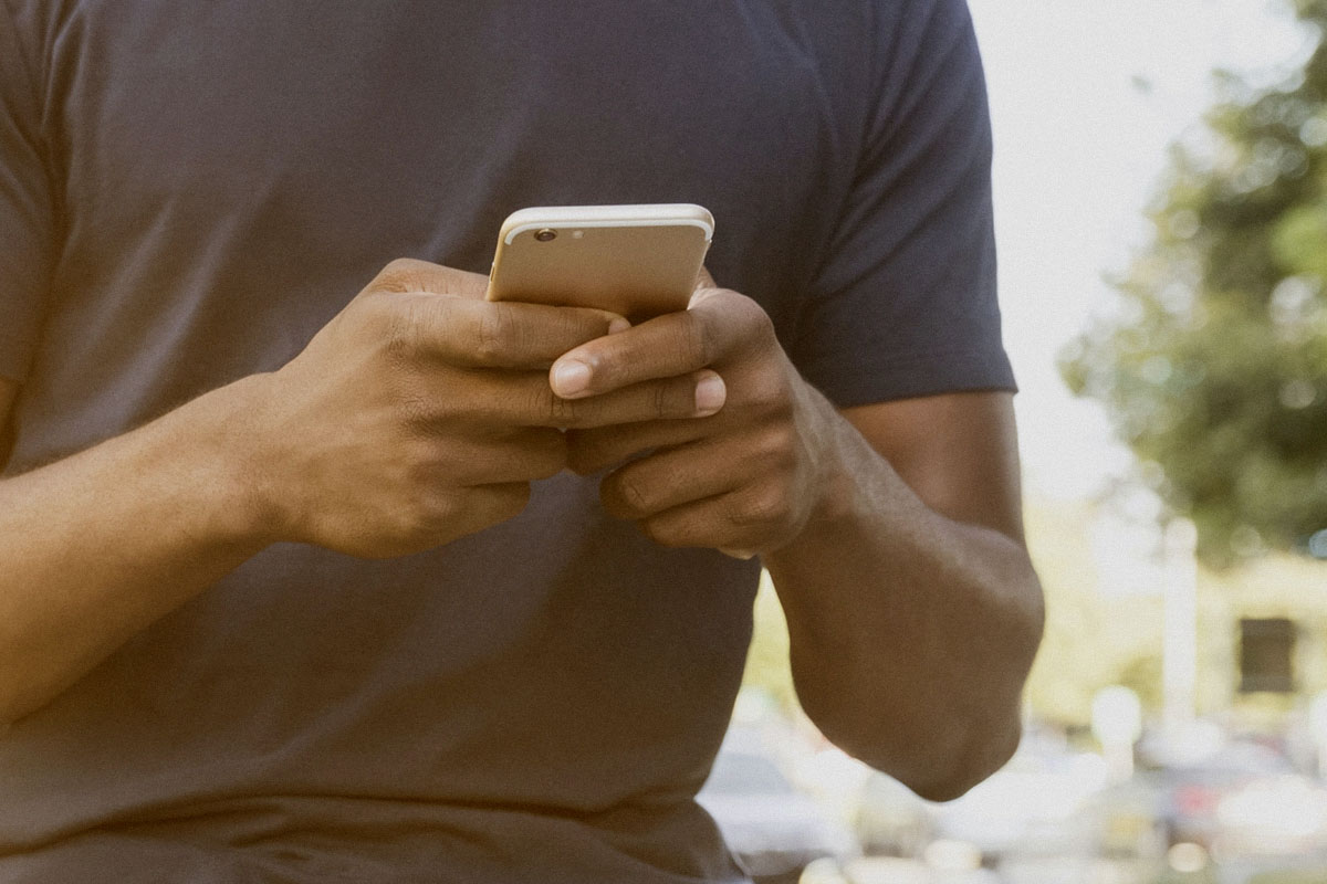 Man sending a message on his smartphone