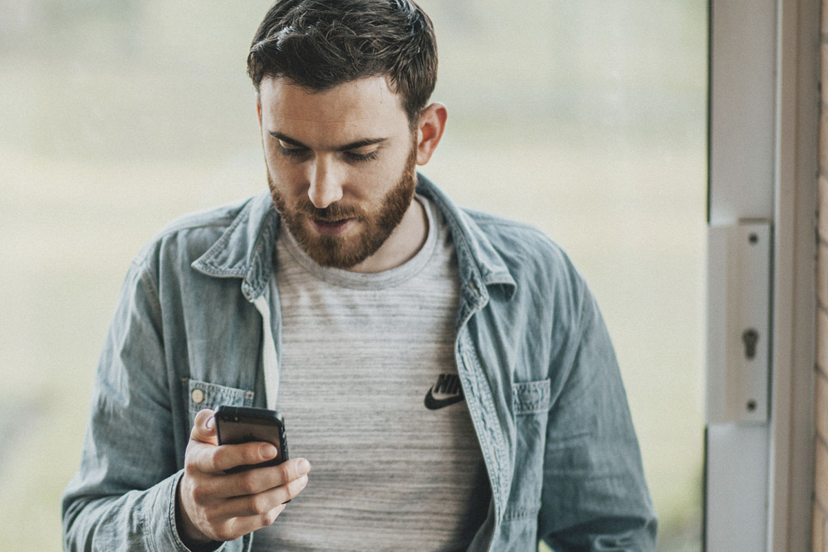 Young man reading on his smartphone 