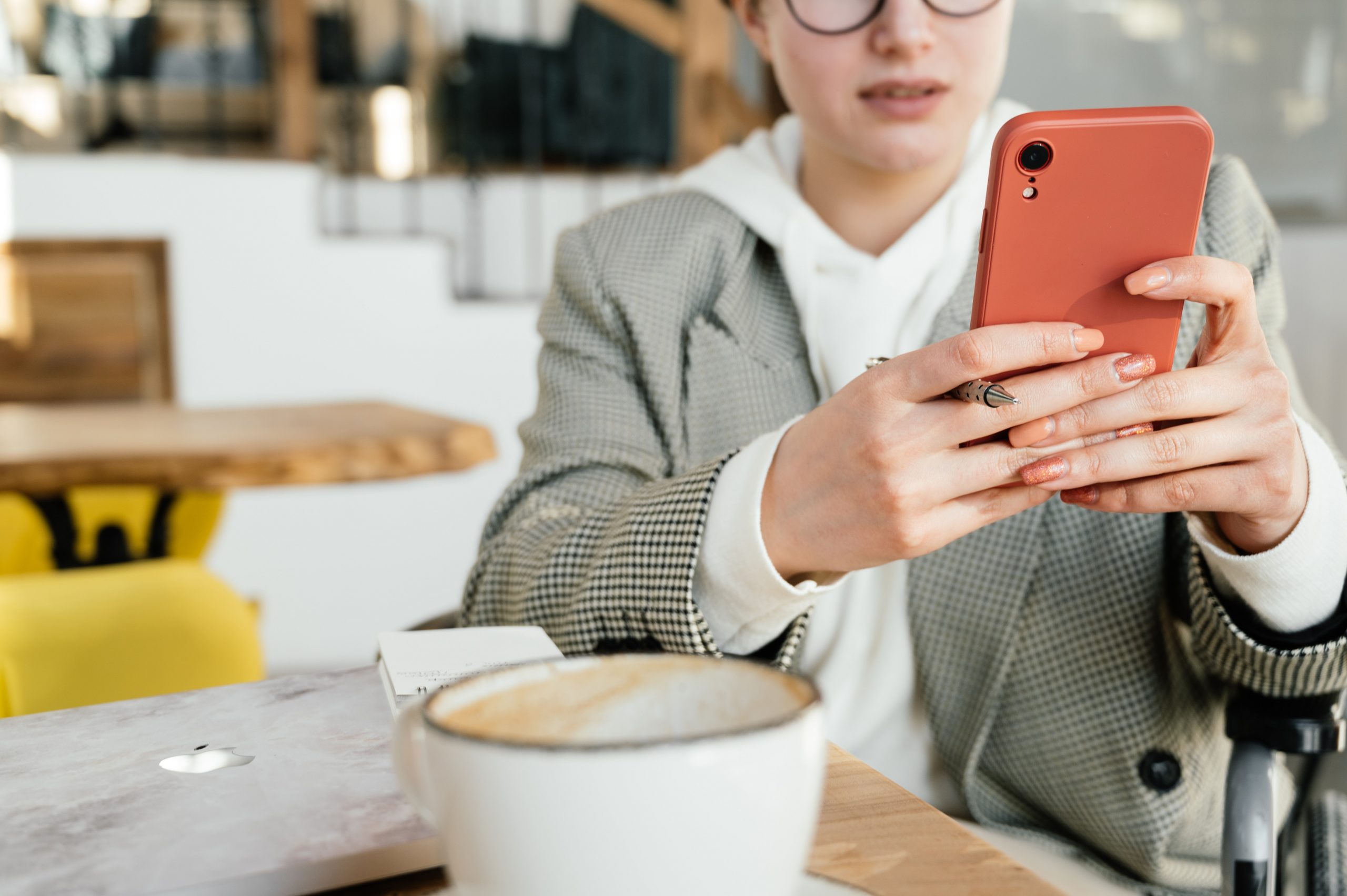 Photo of businesswoman using smartphone in a cafe
