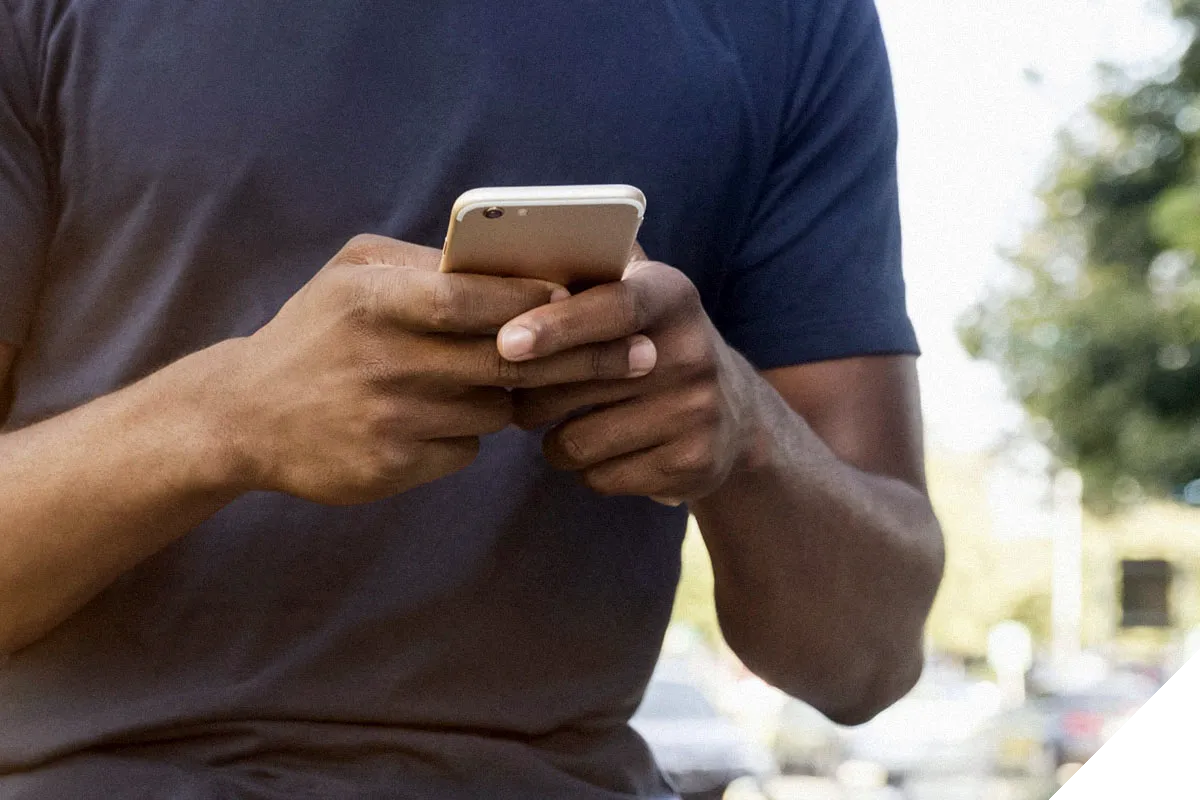 man interacting with his mobile phone